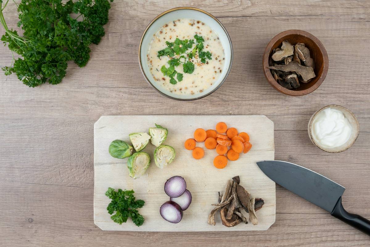 High-Protein organic vegan lentil and quinoa soup simmering in a cast-iron pot